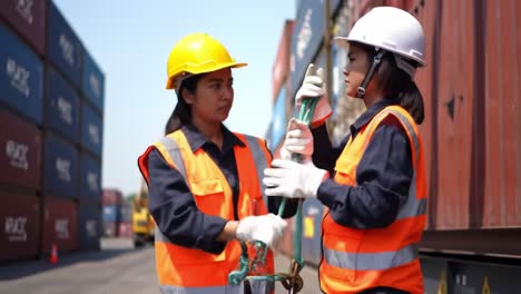 team of workers in high-visibility vests coordinating cargo operations in a shipping yard surrounded by colorful freight containers on a bright sunny day