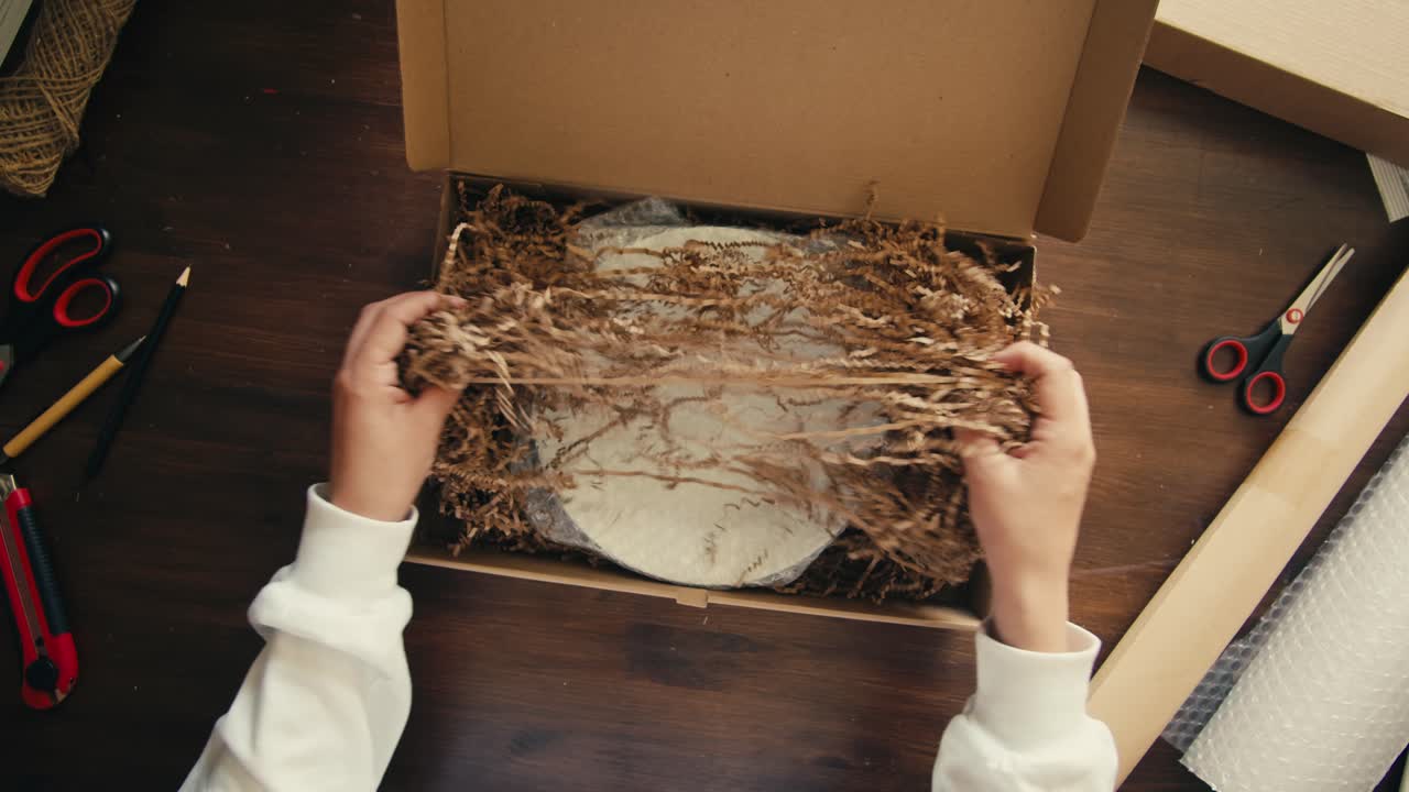 E-commerce storage shop, woman packing goods and clothes for second hand delivery market, dedicated Packaging and Shipping Workspace with Supplies and Technology for efficiency, online sales.