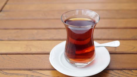 turkish tea in a glass cup on a wooden table