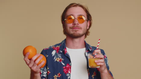 Tourist-young-man-holding-oranges-fruits-vitamins-for-health-drinking-juice-from-straw-organic-eco