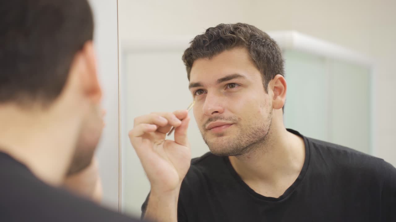 Taking eyebrows with tweezers. Personal care.