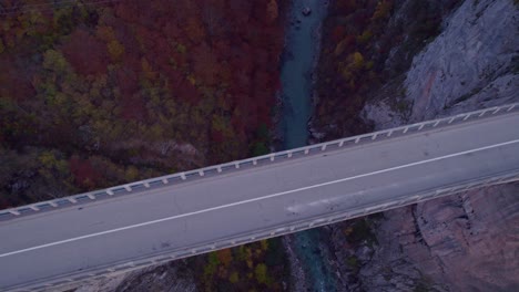 Close-up-of-car-crossing-on-Tara-Bridge-road-in-morning,-aerial