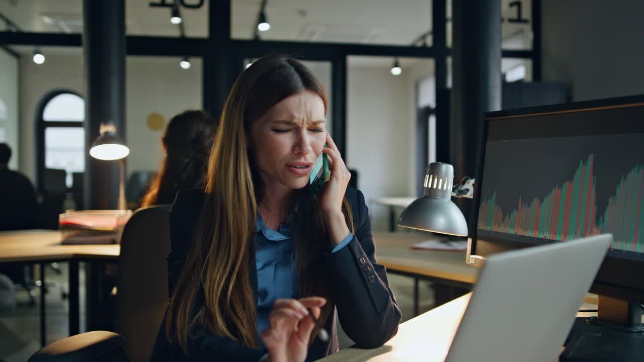 Evening manager speaking cell at workplace. Friendly forex employee talk client