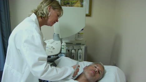 a female technician uses an ultrasound machine on a patient