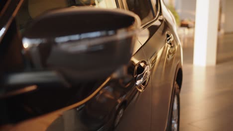 car keyless security concept. driver uses keyless entry access by putting finger on handle to open or close car with fingerprint close up. woman using smart key wireless unlocking car door