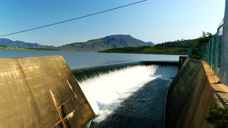 theewaterskloof dam level filled to capacity as water overflows at spillway