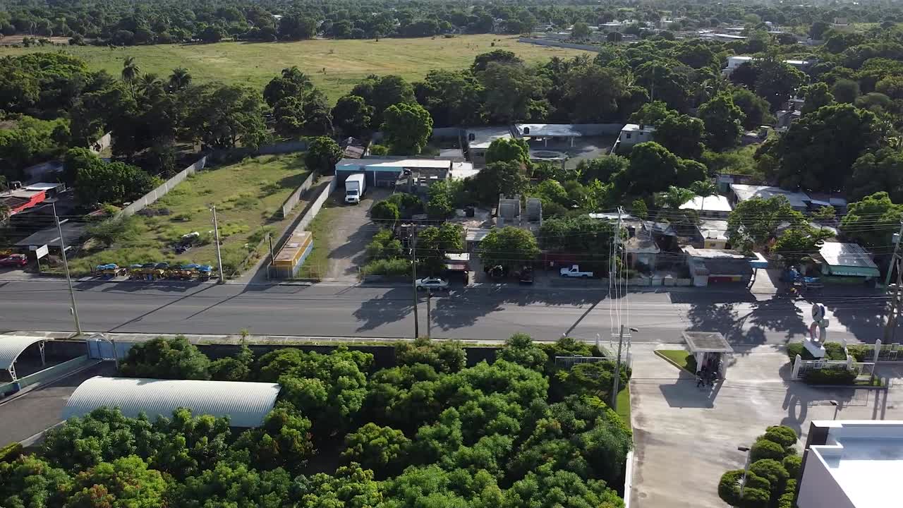 panoramic view of the road to bani, dominican republic, light traffic of commercial cars, rural area