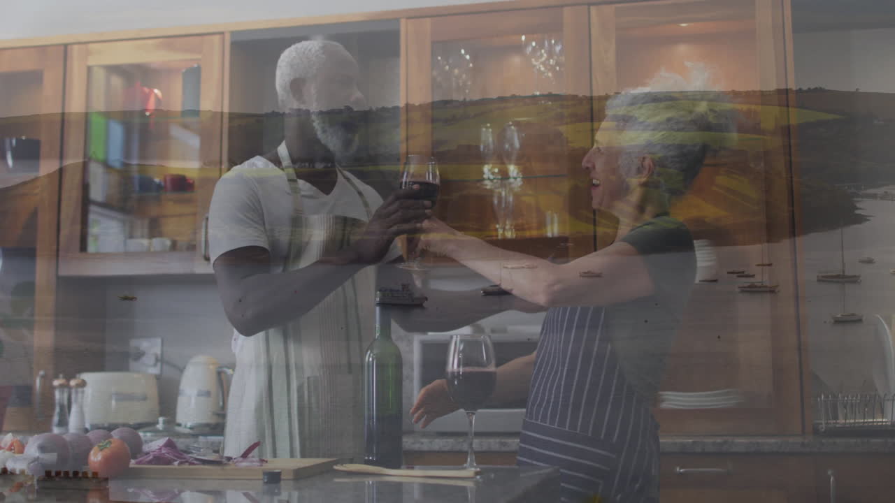 In kitchen, couple holding wine glasses with scenic animation of boats and hills