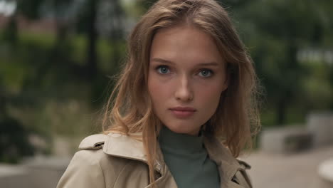 caucasian woman looking at the camera outdoors.