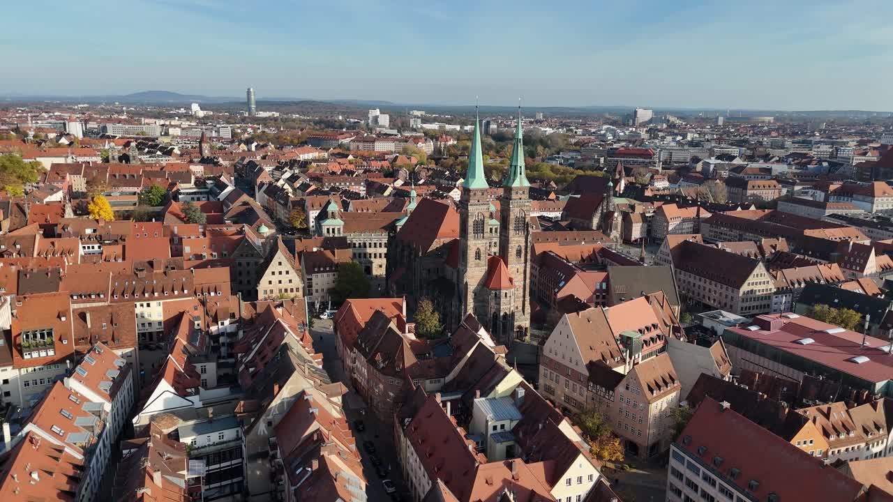 Drone makes a circular move around St Sebald Church from above with dense old town blocks surrounding it