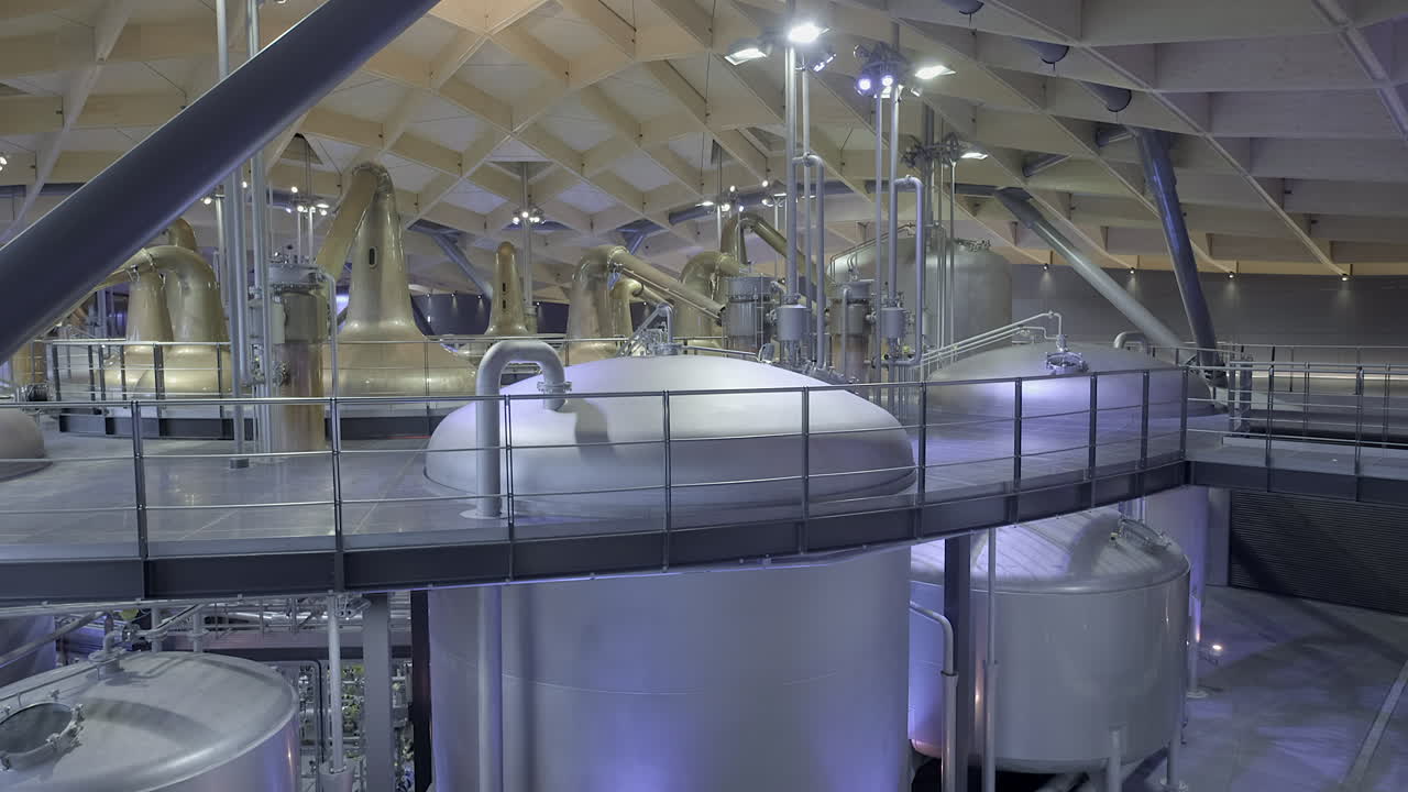 Interior pipework, copper stills and mash tuns highlighting the architecture and complexity of a modern Scottish whisky distillery