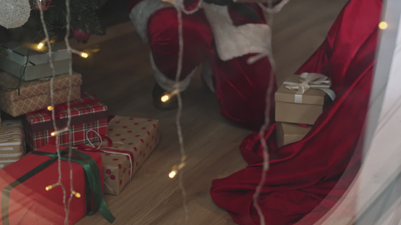 Santa Putting Gift Boxes under Christmas Tree