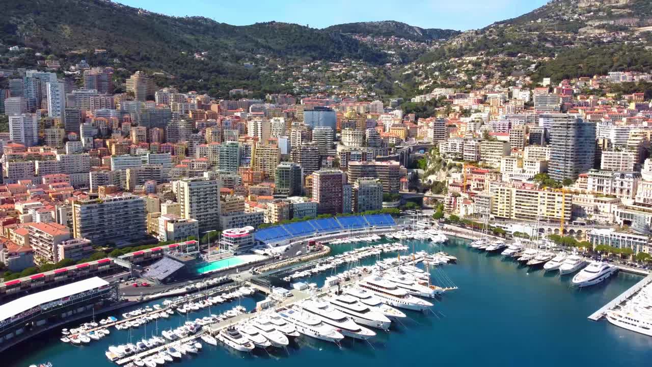 Aerial Monaco harbor with luxury yachts on a sunny Riviera day