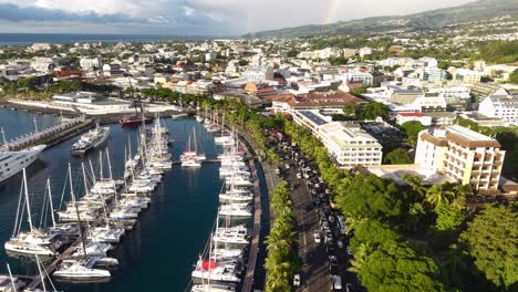 drone shot of papeete, tahiti island, french polynesia, city street traffic, buildings and harbor marina