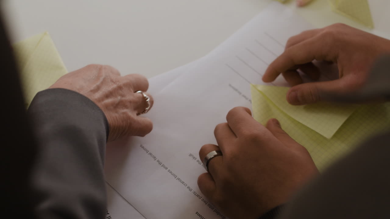 Hands working with documents and notes