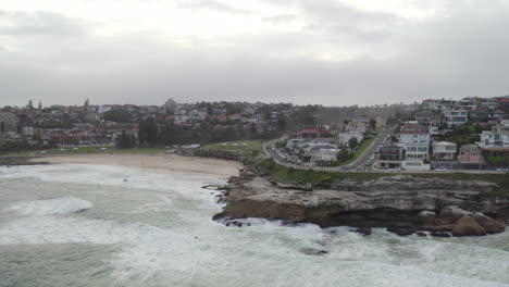 aerial: drone flying over the ocean on an overcast cloudy day past tamarama towards bronte, near bondi sydney