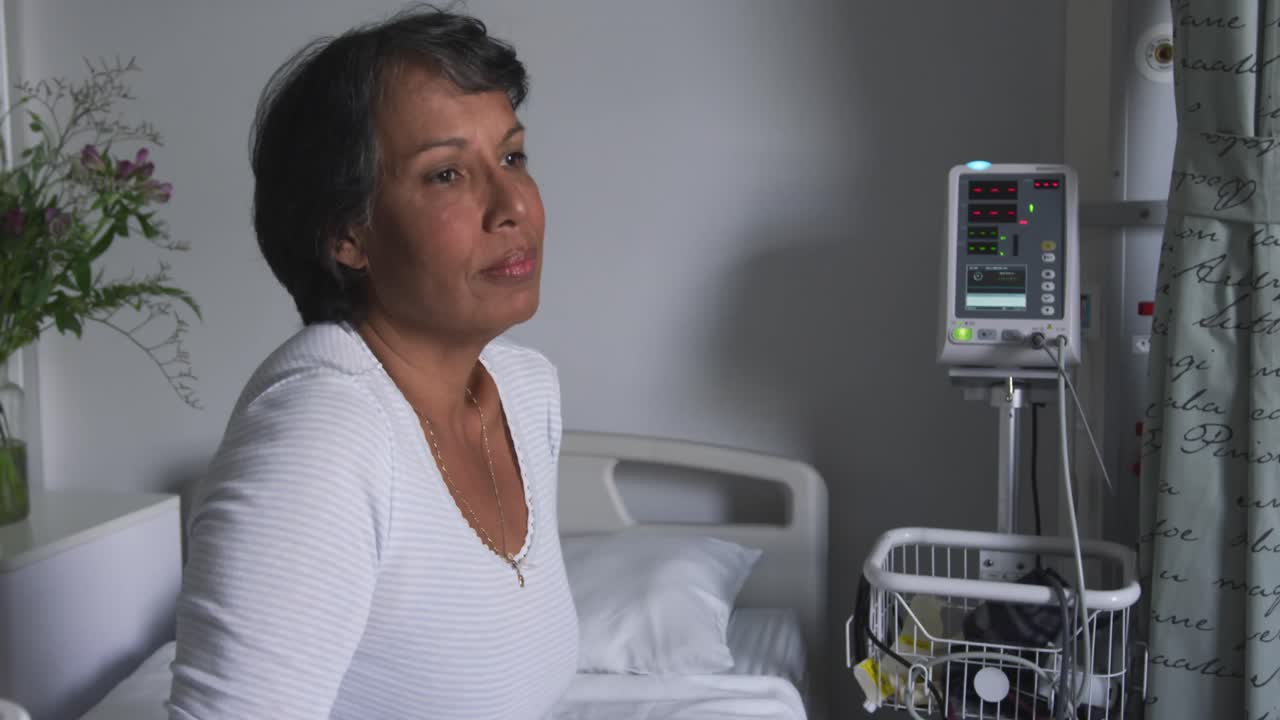 Worried woman sitting on hospital bed 4k