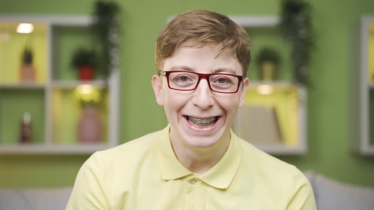 Young man with braces looking at camera close-up