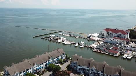 chesapeake beach bay, maryland usa, drone aerial view on upscale condos and hotel with jetty and boats in harbor