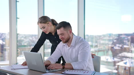 businessman and secretary working together in office. young business partners thinking about new projects in front of a laptop.