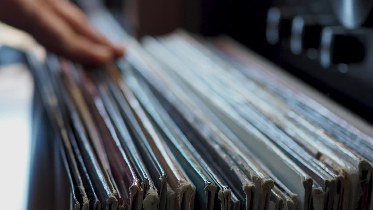 Close up man hands browsing vintage vinyl records at home. Searching music. Scene S