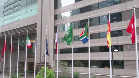 nation flags of switzerland, spain, south africa, saudi arabia, jordan, new zealand, italy, hong kong, and china are seen waving in the wind in hong kong