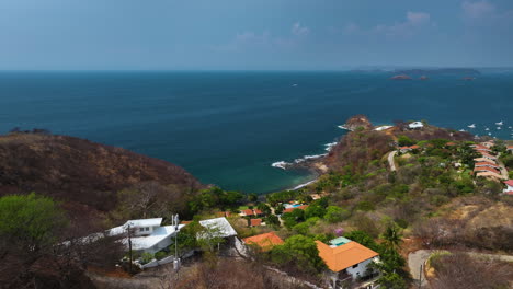 aerial view backwards over of luxury homes at the sea in guanacaste, costa rica