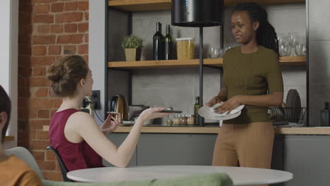 two  roommates talking and spending time together in the kitchen 1