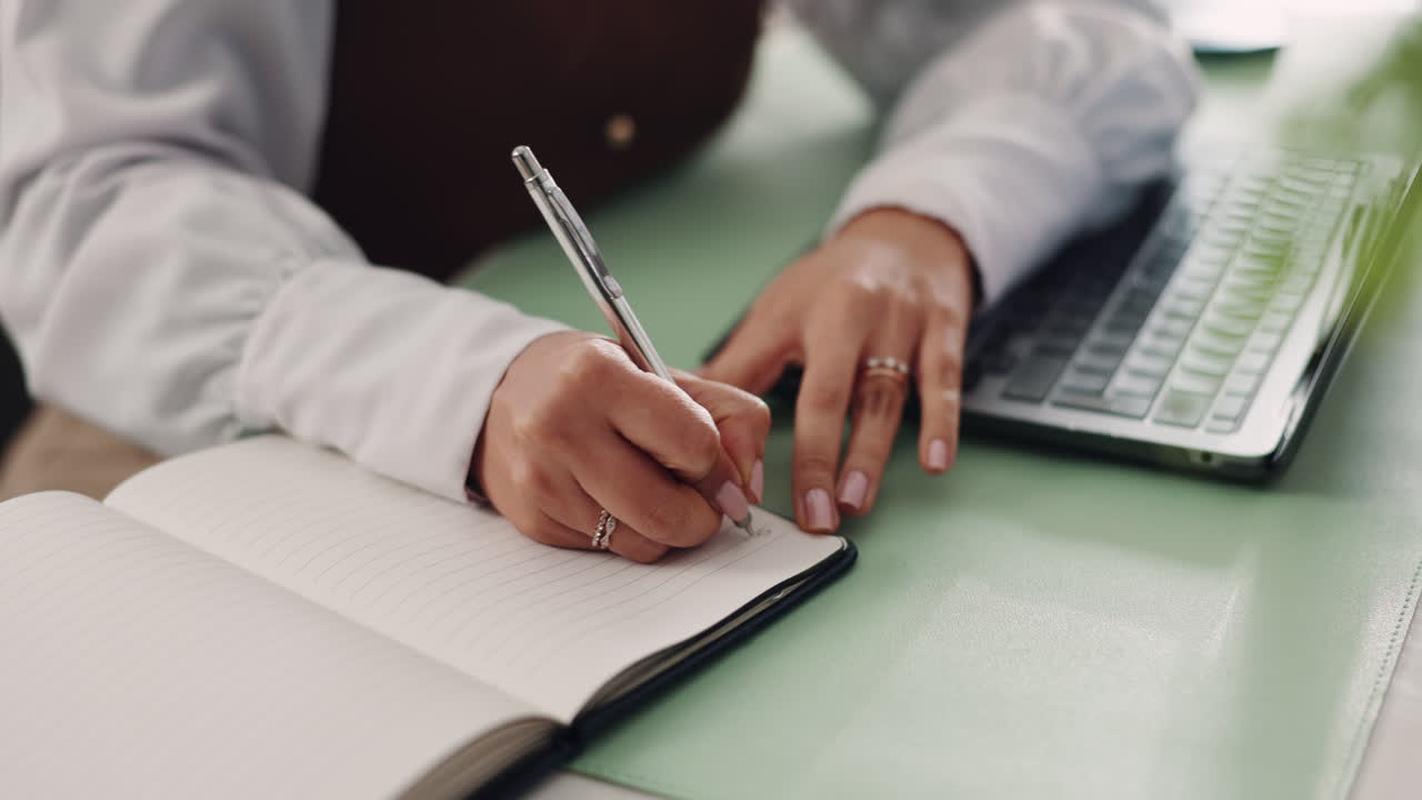 Woman writing in a notebook at her desk
