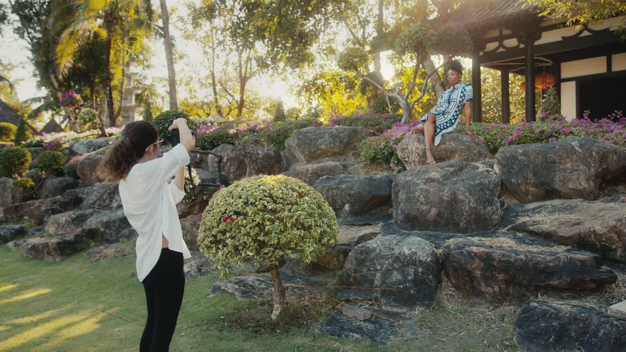 Photographer taking photos of a model in a tropical garden
