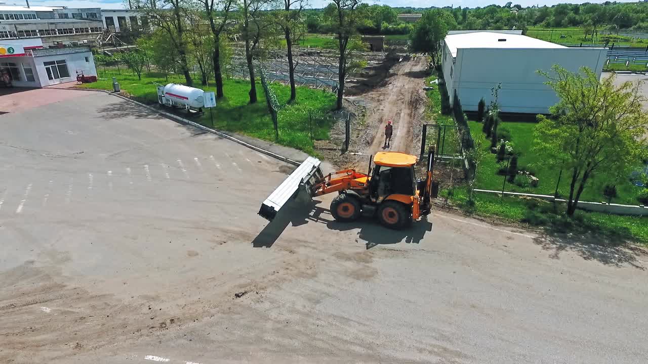 Working machine on construction. Aerial view of tractor working at construction site