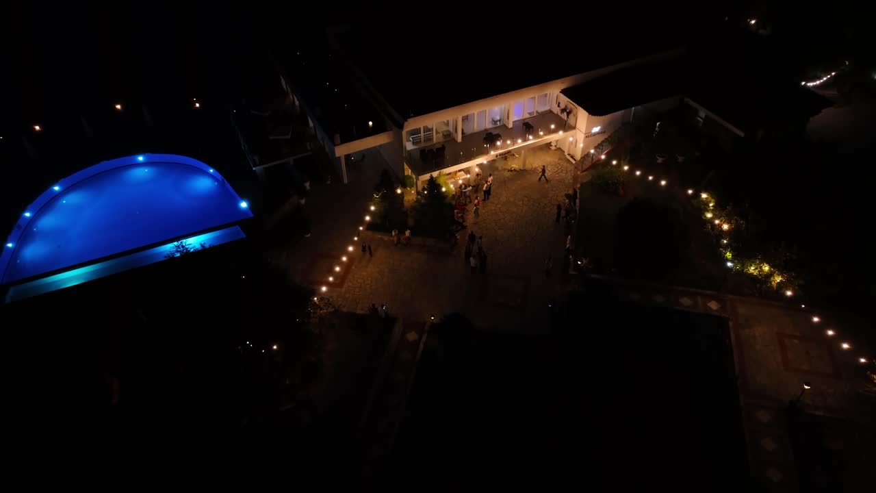 Night aerial view of Alexander The Great Hotel in Halkidiki, Greece, Illuminated pool and pathways, magical evening ambiance.