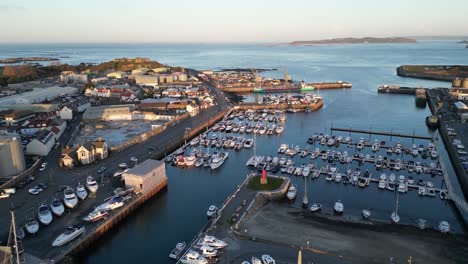 flight over outer harbour st sampson guernsey showing marina, boatyard, ship,docks cranes, vale castle and views out to sea with herm in the distance on calm sunny day