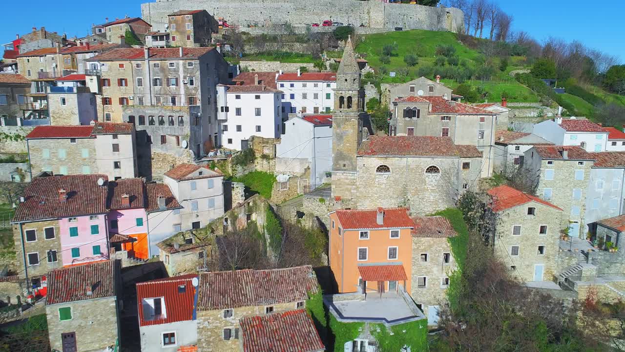 Aerial flying beside a bell tower in Motovun, a medieval town in central Istria, Croatia