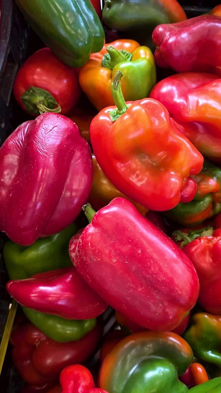 Vibrant red and green bell peppers piled together, fresh and colorful