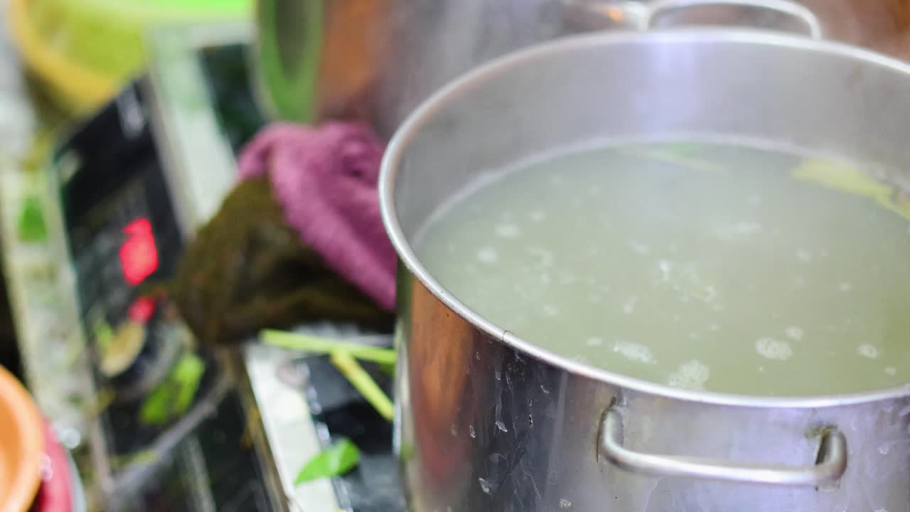 Water boiling with bubbles in a stainless steel pot