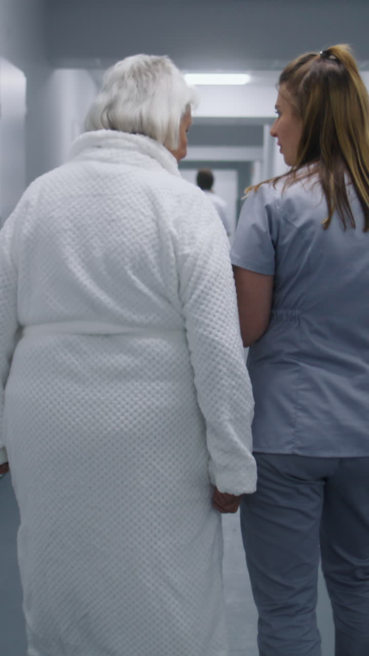 Female doctor and elderly patient talk walk along 4k 2025 08 04 21 43 17 utc.mov | assistance, care, clinic, concept