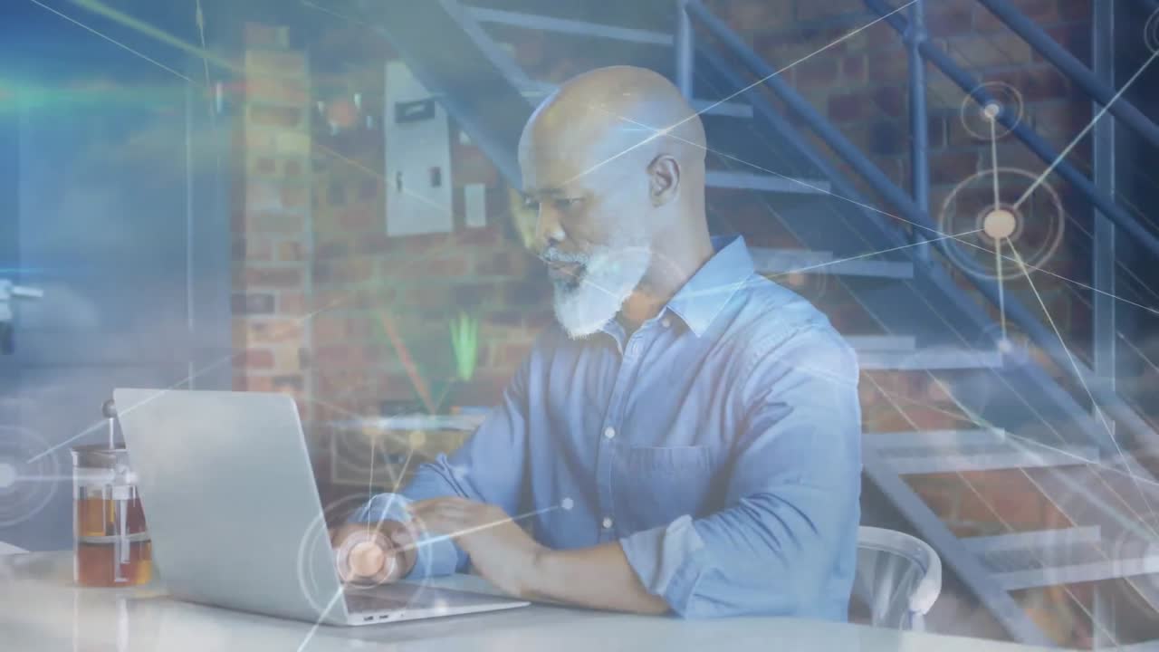 Animation of networks of connections over senior man using laptop