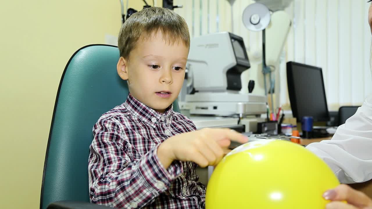 Eye examination. Little boy doing eye test optical clinic
