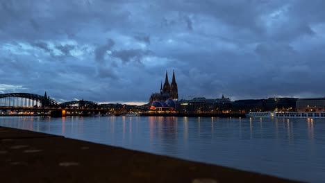 timelapse of cologne from day to night lights go on at the cathedral and the bridge