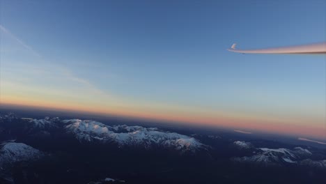 wing of a glider pilot flying over the alps between the border of austria ( innsbruck) and germany ( zugspitze)