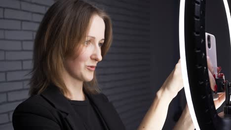 footage of blogger woman with ring led lamp