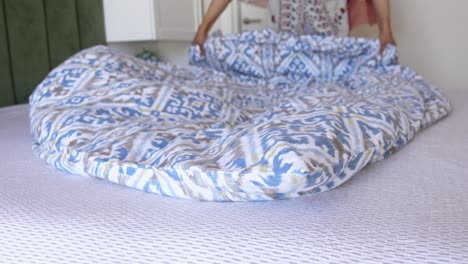 closeup of a bed with a patterned comforter