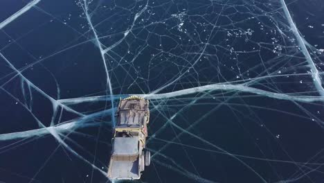 Drone-chasing-forward-over-DIY-built-cars-on-icy-surface-lake-in-Russia