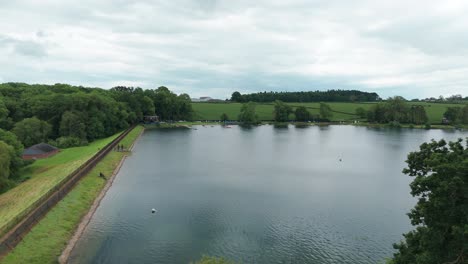 A-calm-time-near-Kettering-Reservoir:-surrounded-by-bright-green-trees-a-reservoir-attracts-people-to-relax