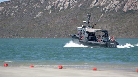 a grey boat sailing on the ocean