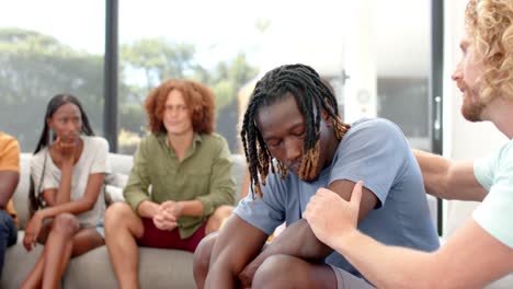 Emotional-diverse-male-friends-talking-and-embracing-during-group-therapy-session,-slow-motion