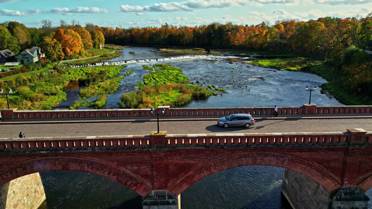 Aerial View of a Red Brick Bridge over a River in Autumn