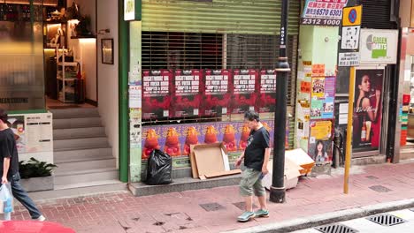 pedestrians pass by a storefront in hong kong