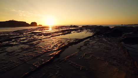A beautiful sunset behind a blowhole in the reef.
